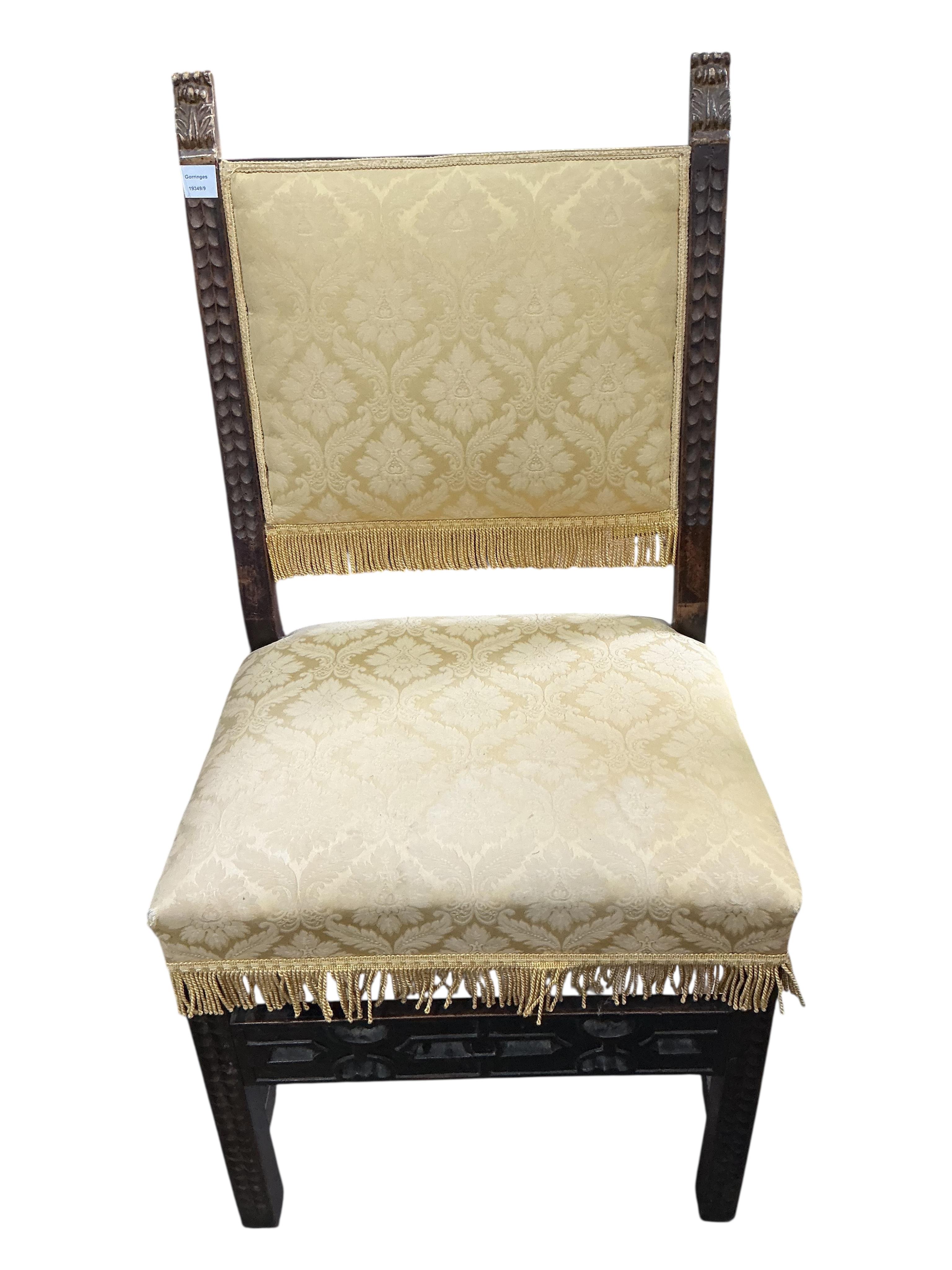 A pair of Italian side chairs carved with foliate bands, parcel gilt terminals and fretwork stretcher, upholstered in yellow damask, width 58cm, depth 48cm, height 118cm